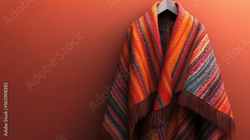 Warmth and Style, A Colorful Striped Shawl on a Wooden Hanger