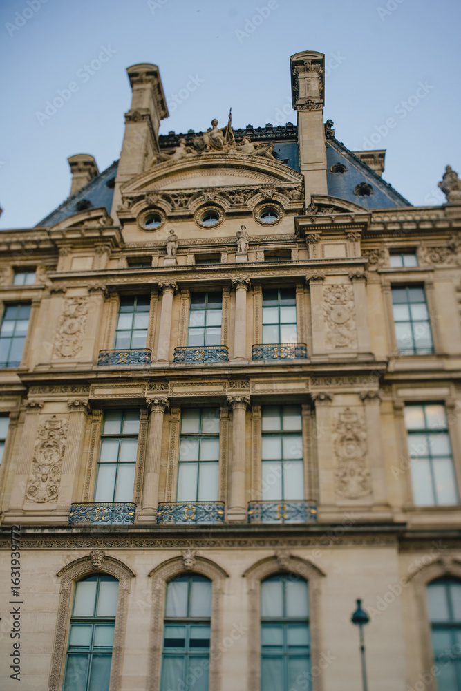 Naklejka premium The facade of a historic building in the center of Paris in Romanesque style
