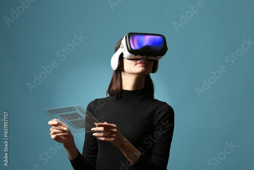 Woman Using VR Headset and Transparent Touch Interface on Blue Background
