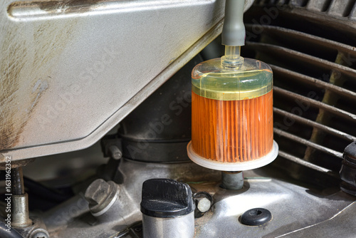 Gasoline fuel filter of  a 2 - stroke motorcycle  .  fuel filter of  motorcycle