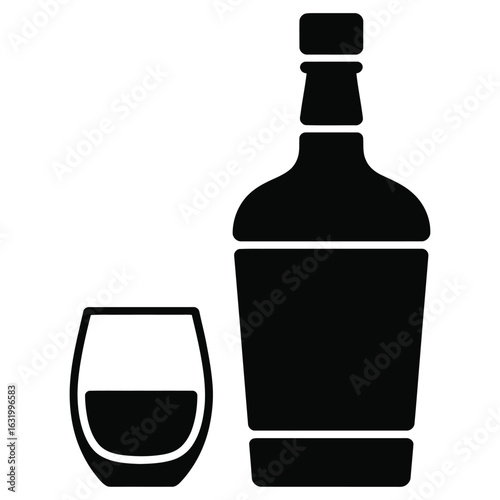Black bottle and glass with dark liquid beverage