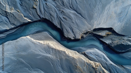 Wallpaper Mural River's Serenity: An aerial view captures a tranquil, flowing river carving its path through the textured landscape, creating a peaceful and mesmerizing display of natural beauty. Torontodigital.ca