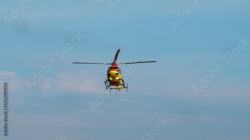 The medical helicopter flies carefully during the journey, arriving at the site of a disaster or emergency in a remote area.