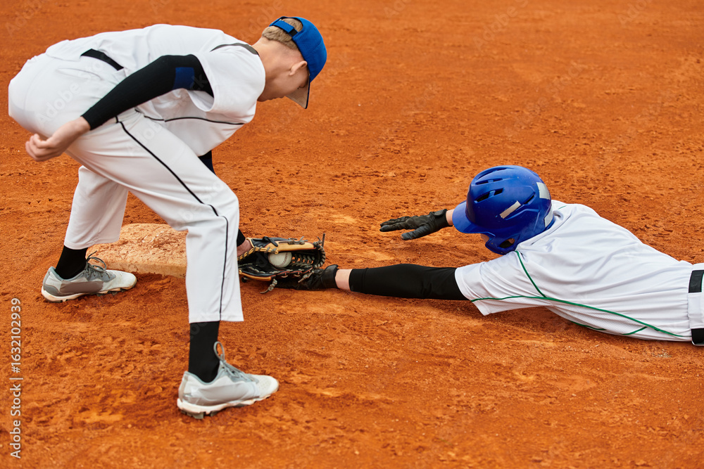 Two teenage boys compete energetically in a thrilling baseball game on the field Two teenage boys compete energetically in a thrilling baseball game on the field