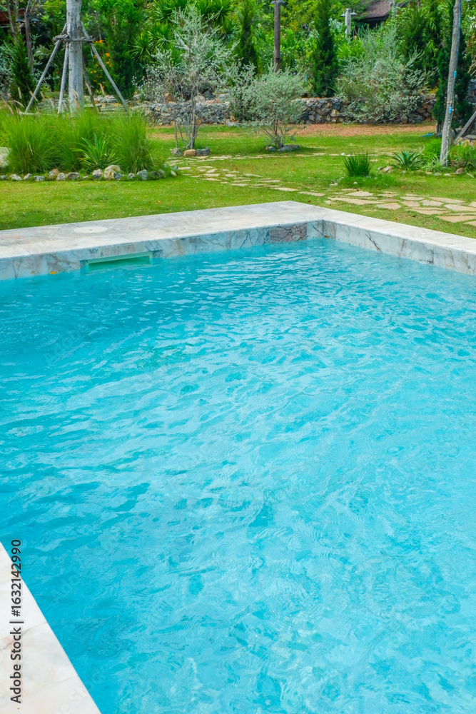 Obraz premium Empty swimming pool with sunbed and white umbrella in resort hotel for vacation leisure and white sand,resort neary sea and beach in summer.