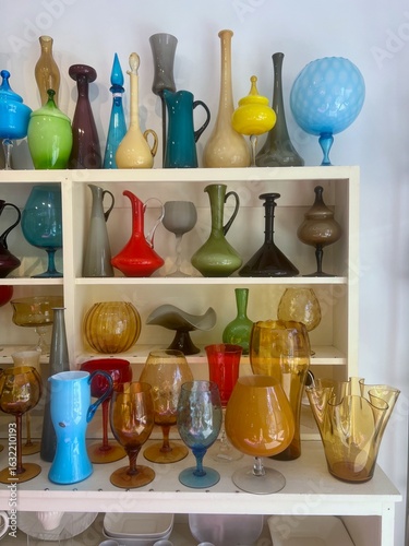 Colorful Midcentury Glassware Collection on Display Shelves