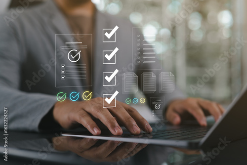 Bild auf Leinwand Automated document approval and quality control concept, Businessman verifies and manages digital paperwork on a laptop using a smart system before final task delivery