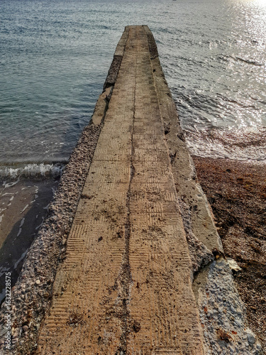 Old stone pier enters the sea