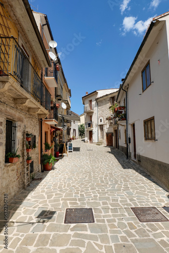 Fototapeta Naklejka Na Ścianę i Meble -  A narrow street among the old houses of Roccascalegna, a small town in Abruzzo, Italy.