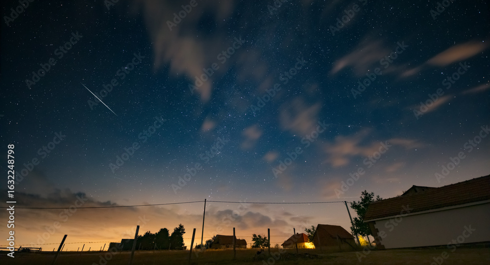 Obraz premium Milky Way stars and rural countryside silhouettes.