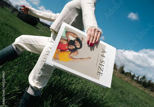 Mockup Of Woman Holding Customized A4 Magazine In Field
