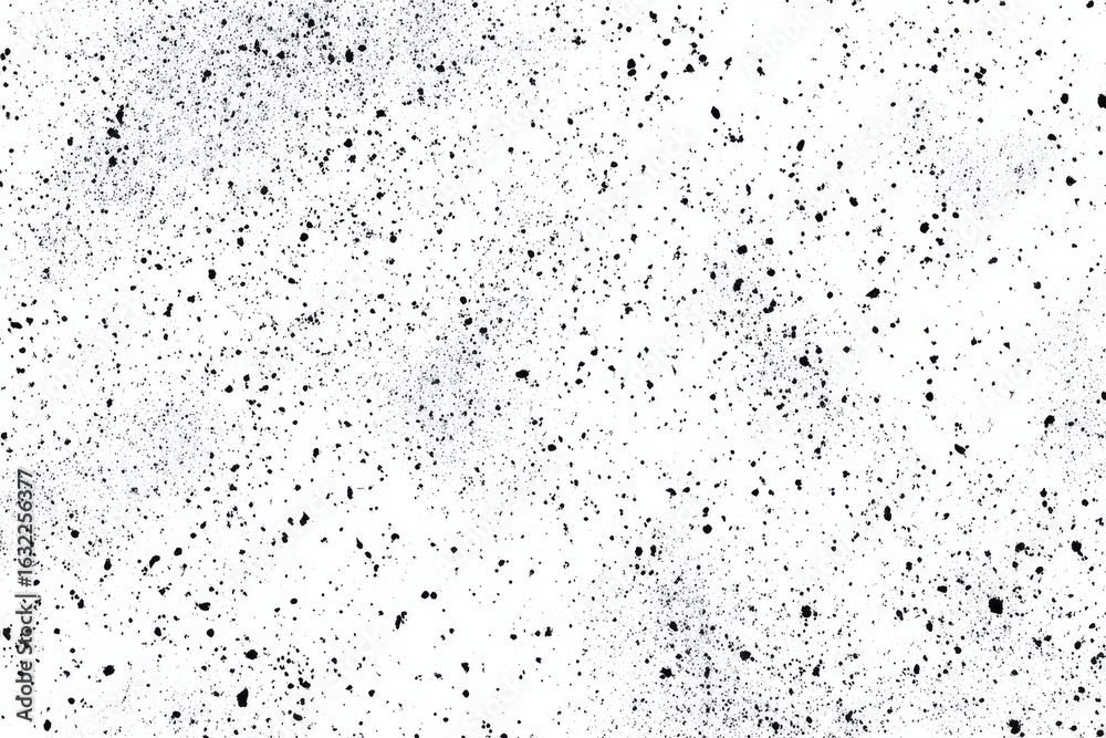 Naklejka premium Abstract monochrome texture of small dark specks scattered across a white background