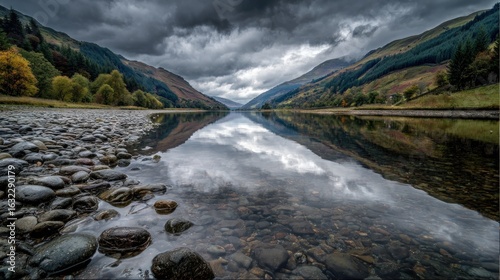 Fototapeta Naklejka Na Ścianę i Meble -  Calm mountain lake reflects stormy sky