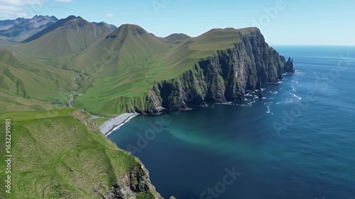 Dramatic Coastal Vista of Green Mountains and Azure Ocean Waters on Sunny Day