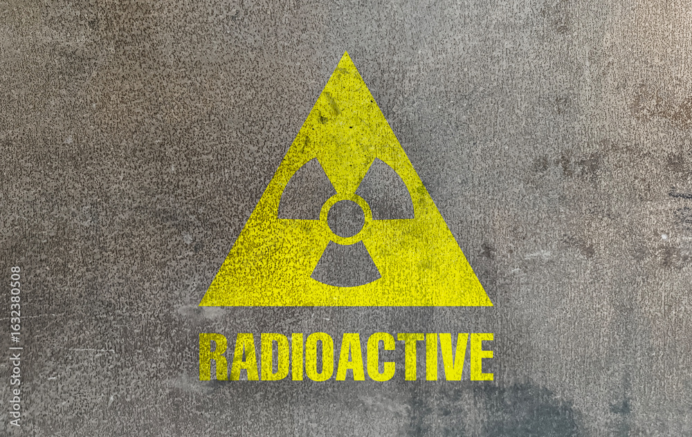 Obraz premium Radioactive sign on grey textured surface. Radiological pollution