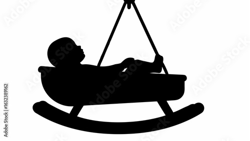 Silhouette of a baby lying in a hanging cradle with a rocking base and hanging strings above it shown