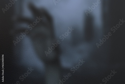 Horrible night scene with hand behind glass against ghost town backdrop, blur effect

