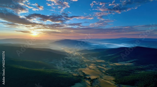 Fototapeta Naklejka Na Ścianę i Meble -  High-altitude aerial of mountain valley at sunset, golden light washing over rolling hills, tranquil and inspiring landscape for meditation or lifestyle stock photo