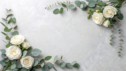 White roses with eucalyptus leaves creating decorative corner border frame on light gray textured concrete surface backdrop.
