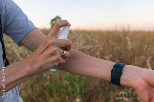 Photos Using repellent to protect from mosquitoes on a windless summer evening