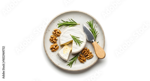 Camembert cheese with walnuts rosemary on white plate
