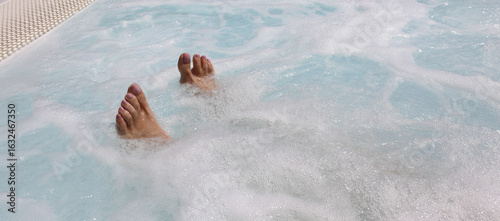 Obraz na plátně feet of the young woman during the hydrotherapy session in the hot tub