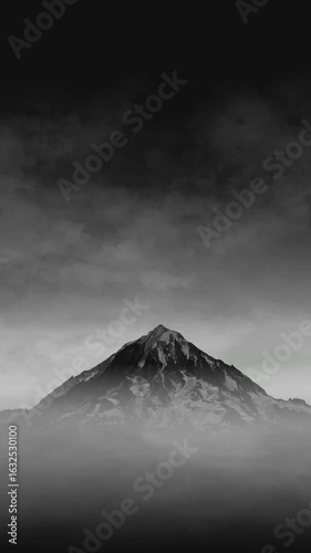 Black and white cloudy mountain peak looping animation background