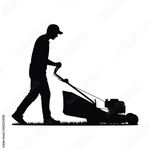Silhouette of a person mowing a lawn with a push mower