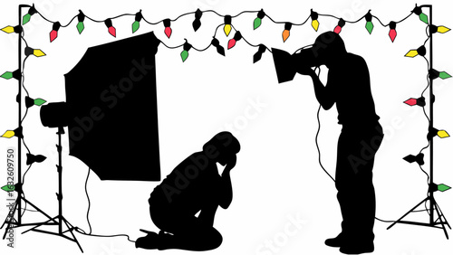 Silhouette of photographer taking picture of kneeling person with christmas lights and studio equipment