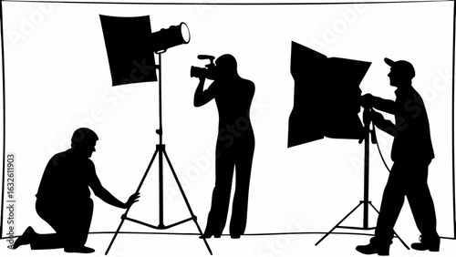 Silhouette of three people in a photography studio with lights and camera equipment in black and white