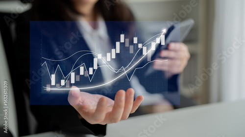 Fotografia A business professional studies stock market trends using a tablet, showcasing digital graphs in a modern office setting, emphasizing financial growth and analysis