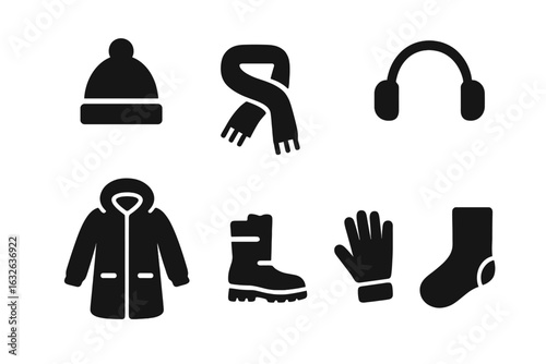 Winter clothing solid icon set. Black filled vector illustration of hat, scarf, earmuffs, parka coat, snow boots, gloves, wool socks. Essential cold weather accessories isolated on white background