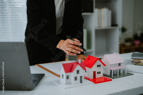 Wallpaper Mural Female woman hand holding home model, investment small miniature white toy house. Mortgage property insurance dream moving home and real estate concept Torontodigital.ca