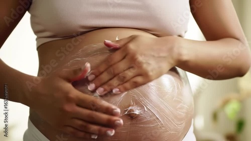 Wallpaper Mural Pregnant woman applying lotion to belly Torontodigital.ca