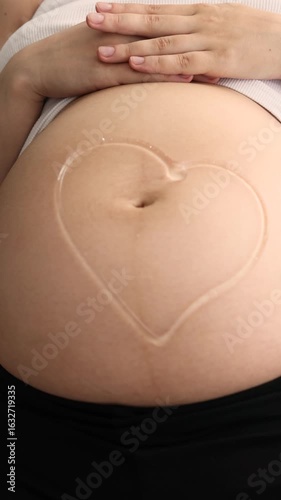 Wallpaper Mural Smiley face drawn with ultrasound gel on pregnant belly by doctor  Torontodigital.ca