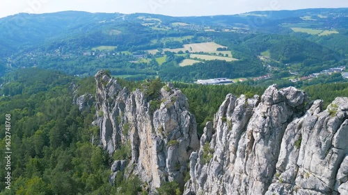 Discover the stunning dry rocks of Bohemian Paradise in Czechia, showcasing impressive sandstone formations surrounded by lush green forests and an expansive landscape. Ideal for climbing enthusiasts.