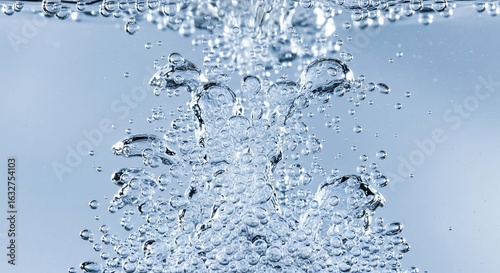 Close-up of clear water with numerous rising bubbles and turbulent flow