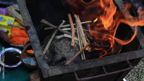 Authentic scene of a traditional Indian marriage vidhi, capturing sacred rituals performed around the holy fire (Agni) under a decorated mandap.