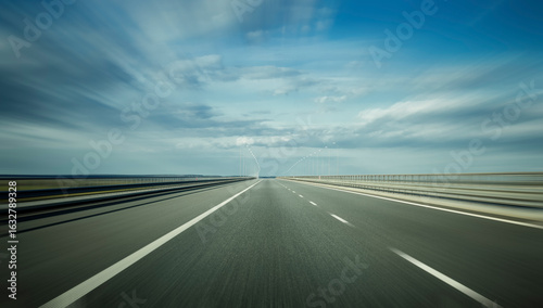 An empty highway on a partial cloudy summer day as symbol of focus on the goal