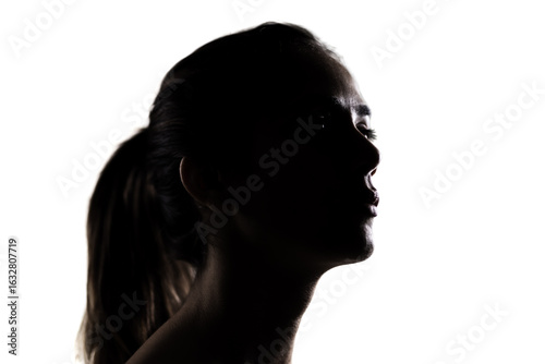 Photography Silhouette portrait of a young woman, dramatic lighting in a studio setting