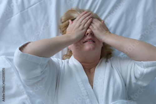 do peek-a-boo with your hands lie on the bed. cover your eyes with your palms, squint, play hide and seek