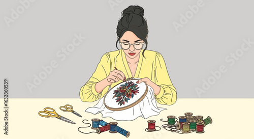 A focused woman with glasses carefully embroiders a colorful floral pattern in a hoop.