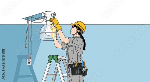 A female electrician in a hard hat changes a light bulb on a stepladder.