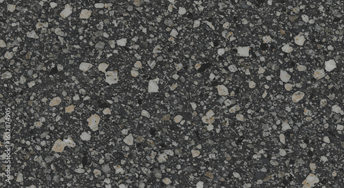 A dense speckled texture filled with a mix of dark and light stones and rock fragments.