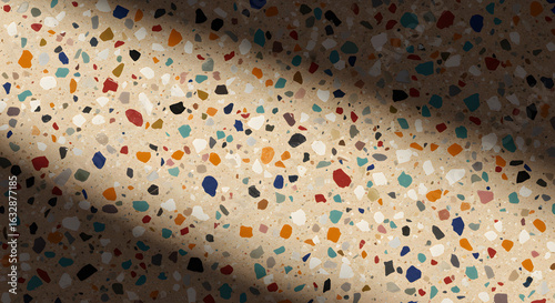 Abstract terrazzo floor pattern, featuring colorful fragments under soft light and shadow effects.