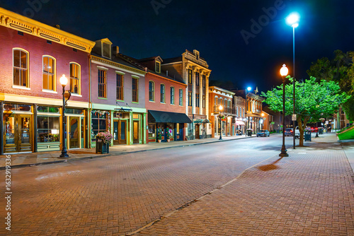 Illuminated nigh view of mid 19th century buildings along the historic brick paved Main Street of St. Charles, Missouri.
