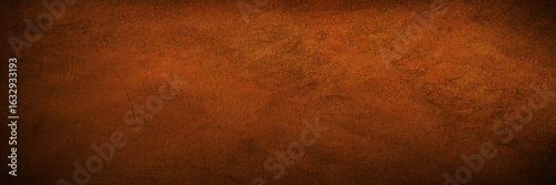 Black dark red brown burnt orange rough grunge texture background. Toned concrete wall surface. Close-up. Space for design. Wide banner. Panoramic.