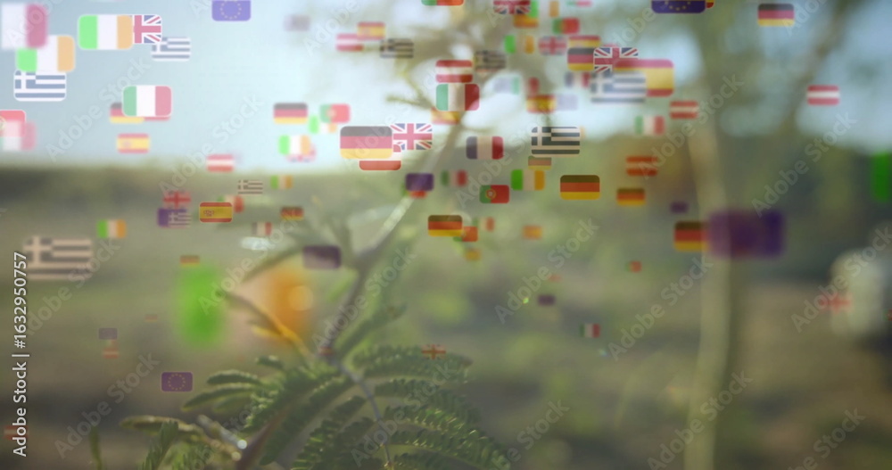 Fototapeta premium Shining slender branch showing pinnate leaves in sunlit field, floating flag icons under sun flare