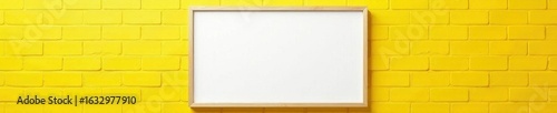 Empty canvas in frame mounted on yellow brick wall background , background, canvas