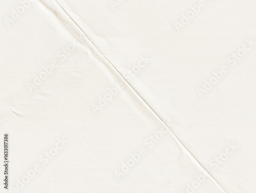 Diagonal crease on off-white textured paper background